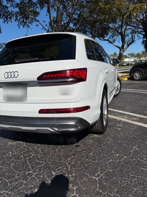 White Audi Q7 rear three-quarter view in a parking lot